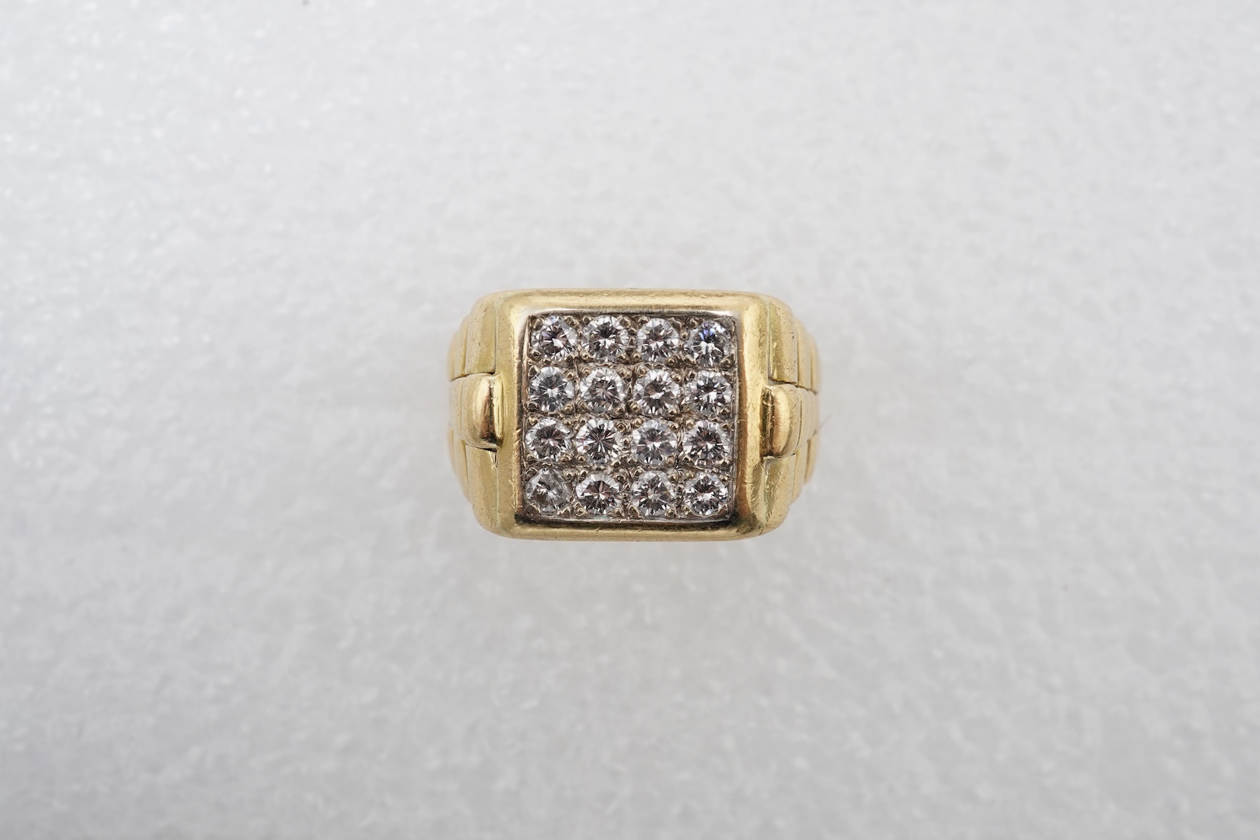 A gold and diamond signet ring